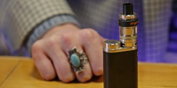 FILE - This March 15, 2017 file photo shows a vape belonging to Branden Kempt, who works at the Future Vapor store in Seattle, rests on the store's counter. Legislators in Washington state have approved on Wednesday, March 27, 2019, a bill to raise the smoking and vaping age there to 21, sending it to Gov. Jay Inslee for his signature. Supporters say the measure would help eliminate youth smoking, but at least one national anti-tobacco group has criticized its enforcement mechanisms. (AP Photo/Ted S. Warren, File)